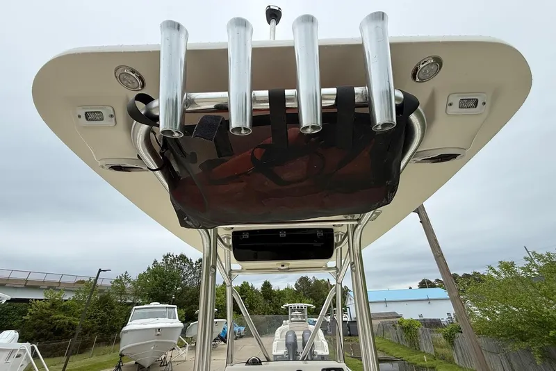 Slide: The Image of 2016 Key West 219 FS boat with rod holders and T-top, docked outdoors. - 23