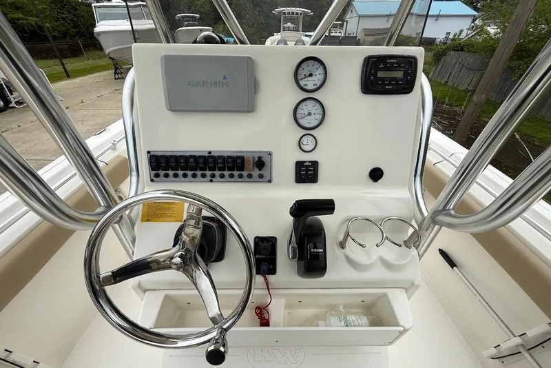Slide: The Image of Steering console of a 2016 Key West 219 FS boat with gauges and controls. - 25