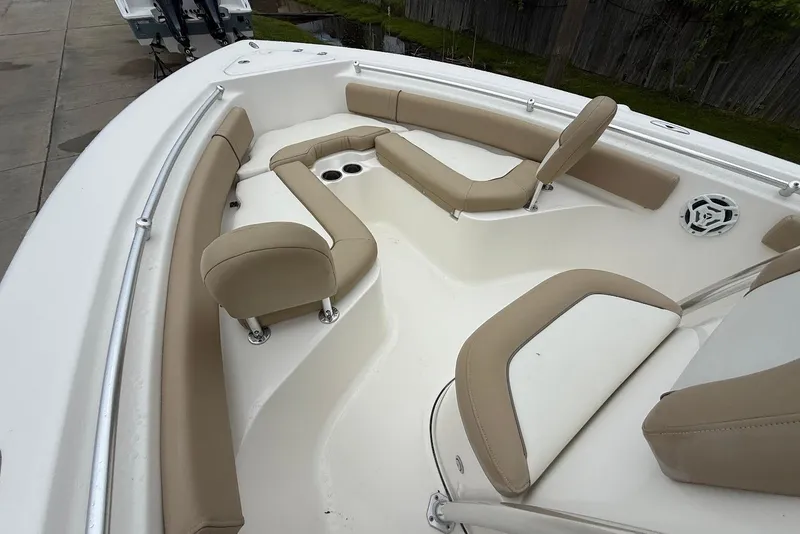 Slide: The Image of 2016 Key West 219 FS boat interior with beige seating and cup holders. - 30