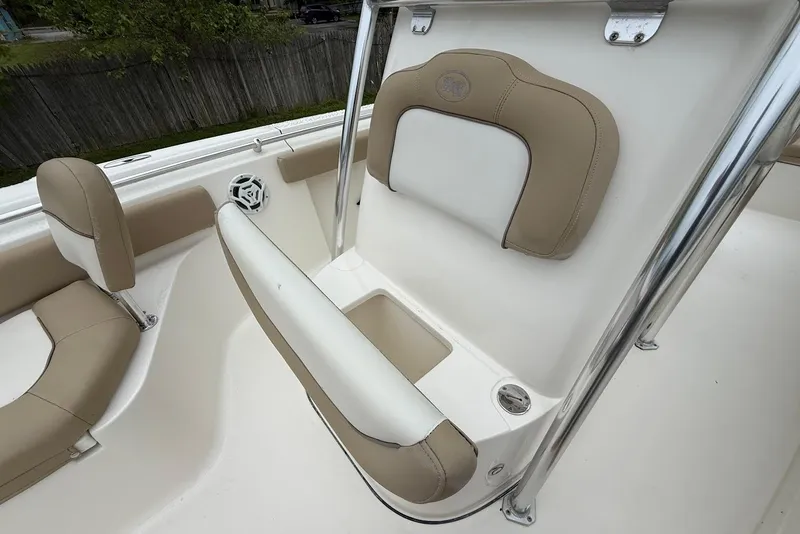 Slide: The Image of 2016 Key West 219 FS boat interior with beige seating and stainless steel accents. - 31