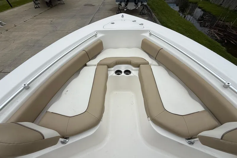 Slide: The Image of 2016 Key West 219 FS boat interior with beige seating and cup holders. - 32