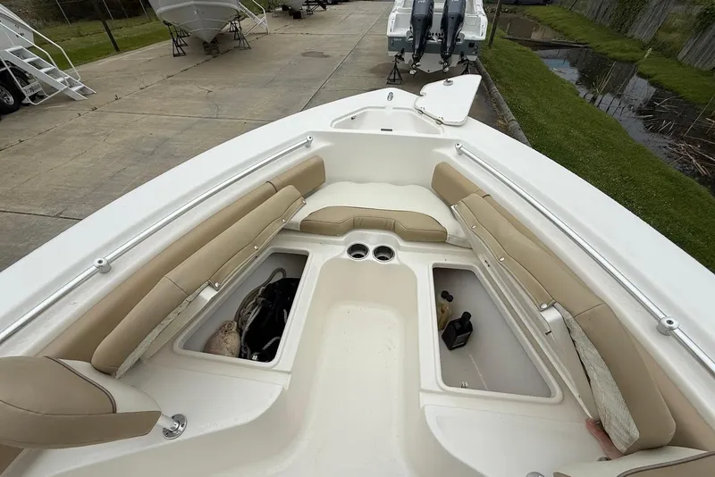 Slide: The Image of 2016 Key West 219 FS boat interior with beige seating and storage compartments. - 33