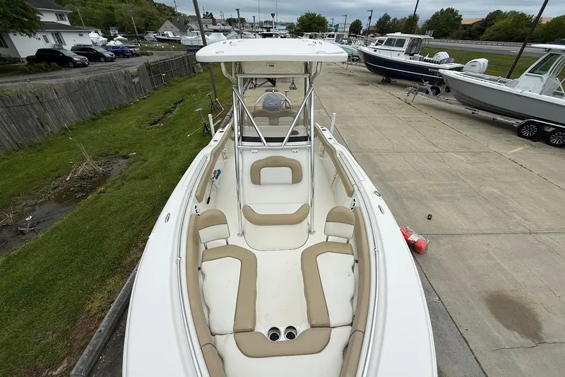 Slide: The Image of 2016 Key West 219 FS boat with beige seating, docked in a marina. - 35