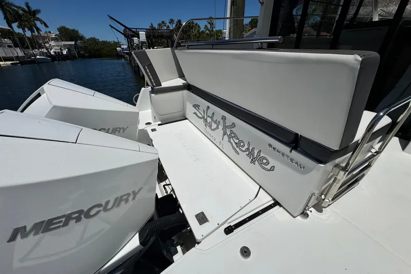 Slide: The Image of 2021 Beneteau Antares 11 boat with Mercury engines, docked near water. - 11