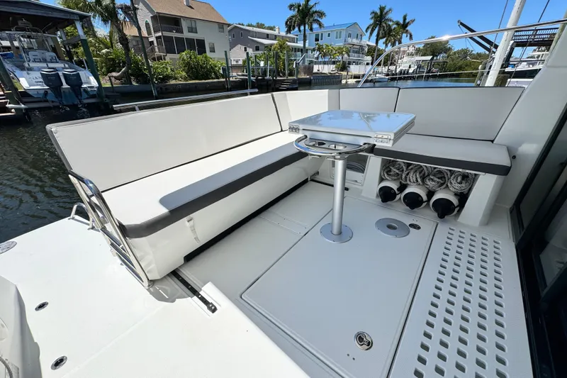 Slide: The Image of Beneteau Antares 11, 2021 model, featuring a sleek seating area with a modern table. - 13