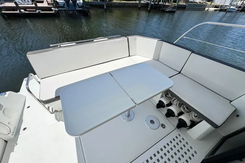 Slide: The Image of Beneteau Antares 11, 2021 model, featuring a spacious outdoor seating area with a table. - 14