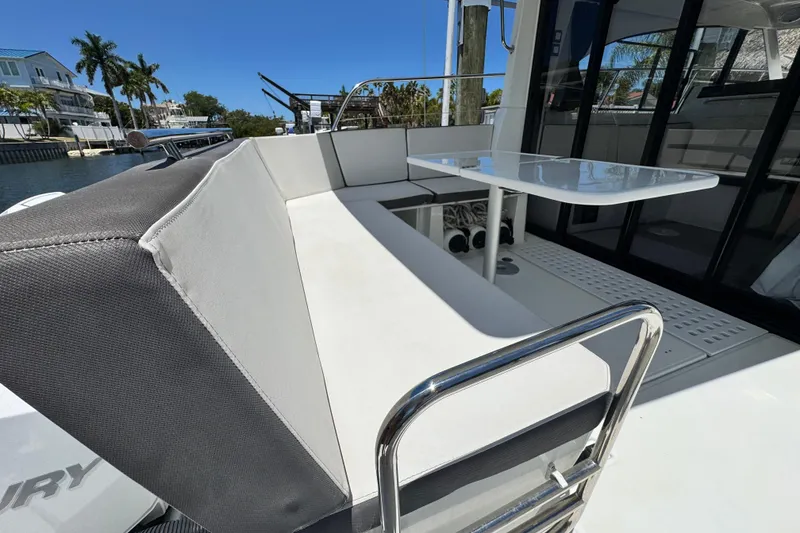 Slide: The Image of Beneteau Antares 11, 2021 model, featuring a sleek outdoor seating area with a table. - 15