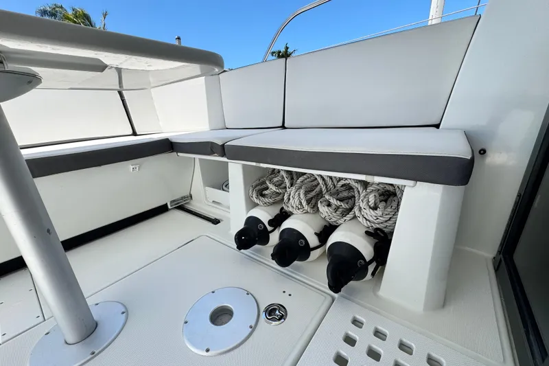 Slide: The Image of 2021 Beneteau Antares 11 boat interior with seating and storage for fenders. - 16