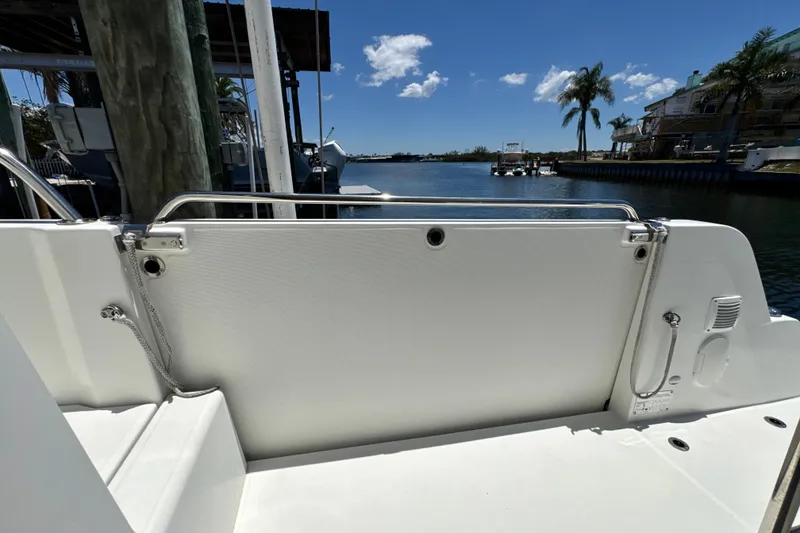 Slide: The Image of Beneteau Antares 11 boat deck, 2021 model, docked by a serene waterfront. - 17