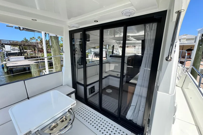 Slide: The Image of 2021 Beneteau Antares 11 yacht interior with sliding glass doors and seating area. - 18