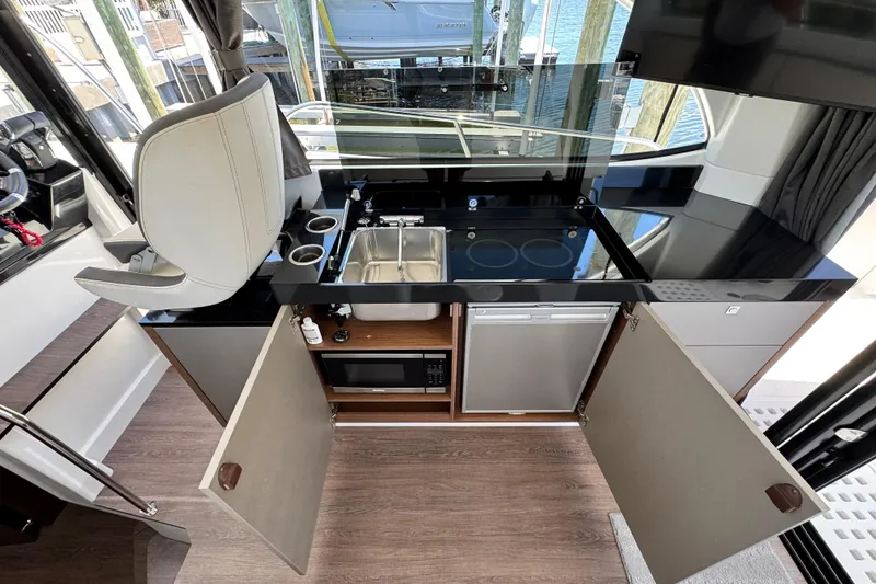 Slide: The Image of Modern kitchen area on 2021 Beneteau Antares 11 yacht with sink, stove, and storage. - 21