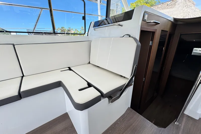 Slide: The Image of Interior of 2021 Beneteau Antares 11, featuring sleek seating and modern design elements. - 25