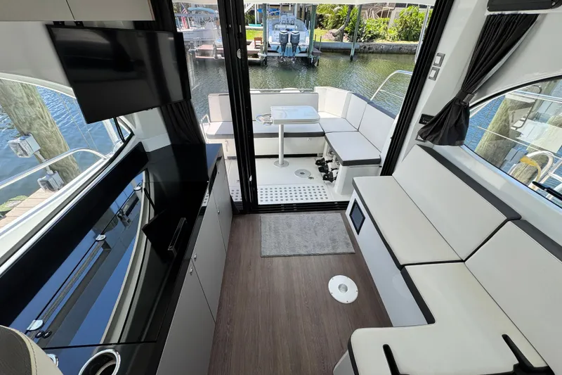 Slide: The Image of Interior of 2021 Beneteau Antares 11 yacht with modern seating and water view. - 27