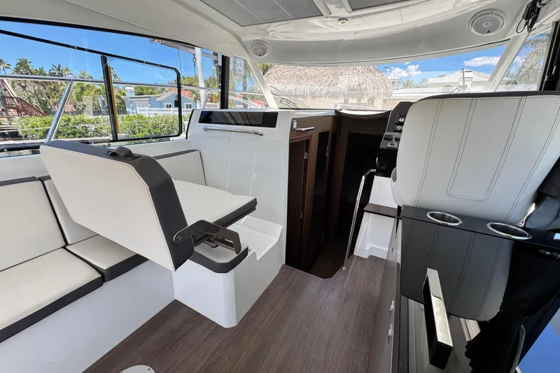 Slide: The Image of Interior of 2021 Beneteau Antares 11 boat with modern seating and helm station. - 28
