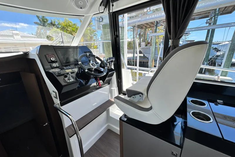 Slide: The Image of Interior helm of 2021 Beneteau Antares 11, featuring modern controls and comfortable seating. - 29