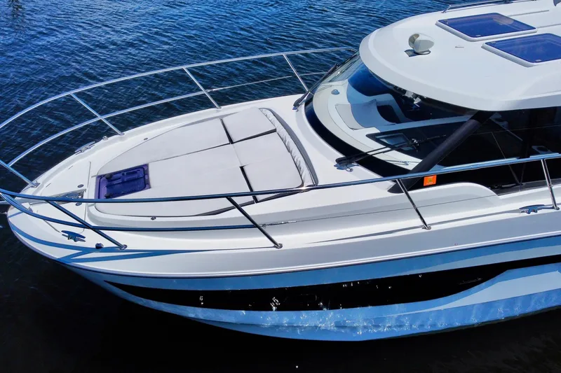 Slide: The Image of 2021 Beneteau Antares 11 yacht on water, showcasing sleek design and spacious deck. - 3