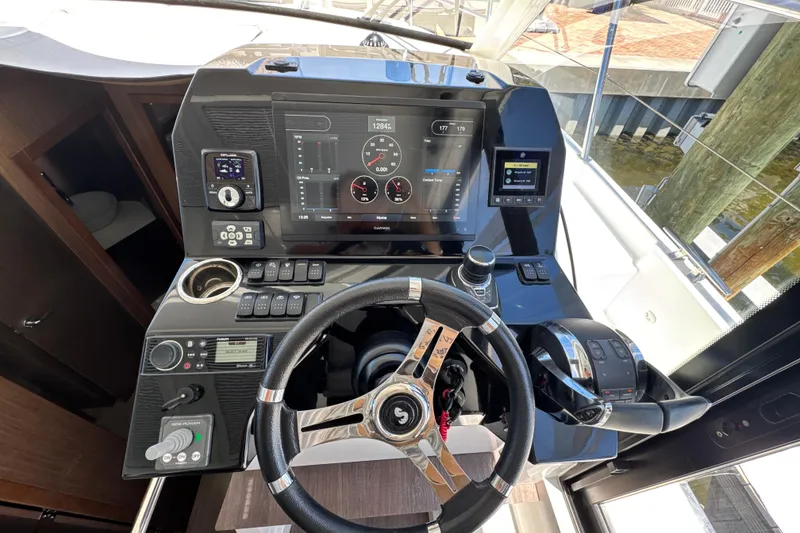 Slide: The Image of Helm of 2021 Beneteau Antares 11 with modern navigation controls and steering wheel. - 33