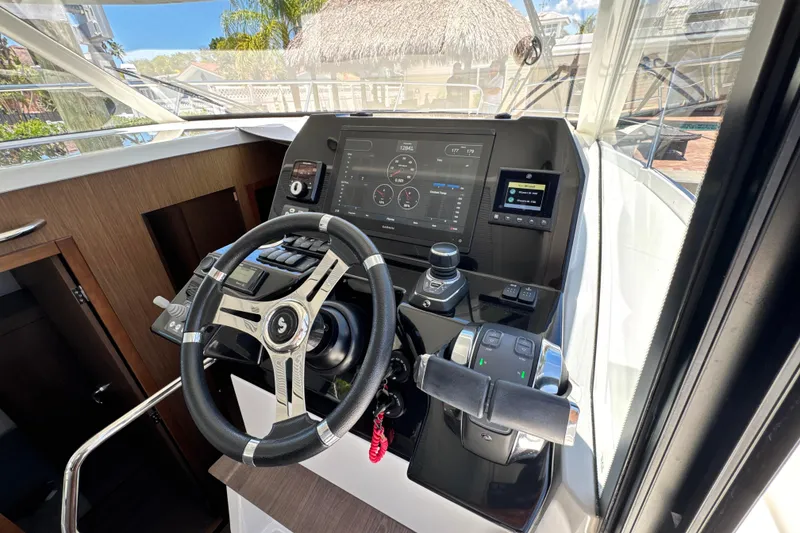 Slide: The Image of Cockpit of 2021 Beneteau Antares 11 with modern steering and navigation controls. - 34