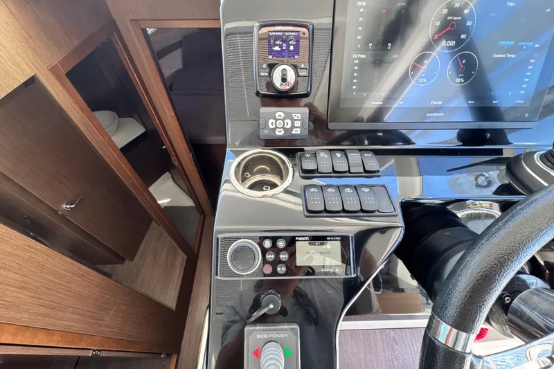 Slide: The Image of 2021 Beneteau Antares 11 cockpit with modern navigation controls and sleek interior design. - 36