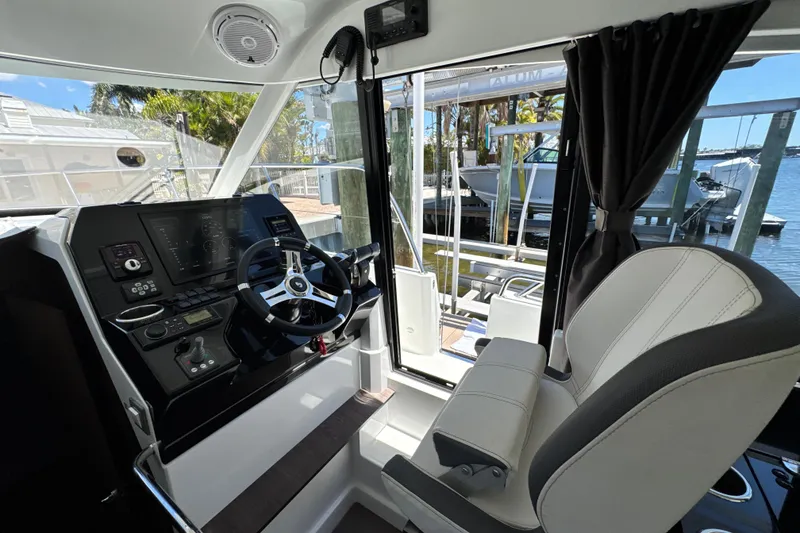 Slide: The Image of Interior helm of 2021 Beneteau Antares 11 with modern controls and comfortable seating. - 39