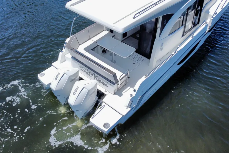 Slide: The Image of 2021 Beneteau Antares 11 boat with dual outboard motors on water. - 4