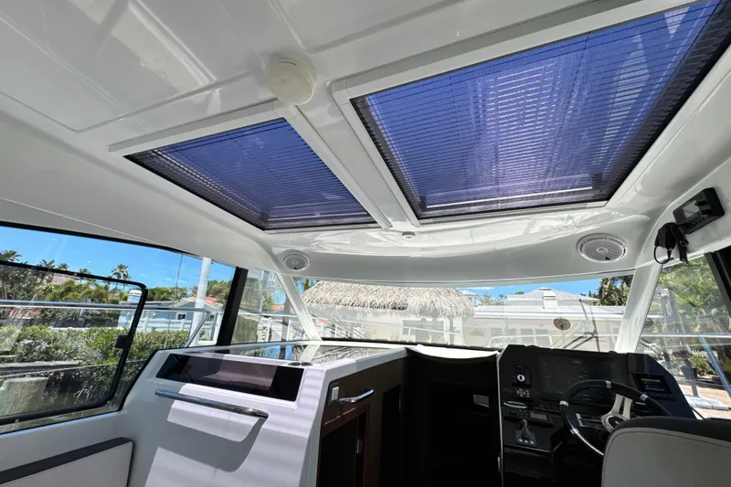 Slide: The Image of Interior view of 2021 Beneteau Antares 11 with sunroof and modern helm station. - 41