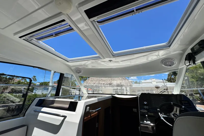 Slide: The Image of Interior view of 2021 Beneteau Antares 11 boat with skylights and modern helm. - 43