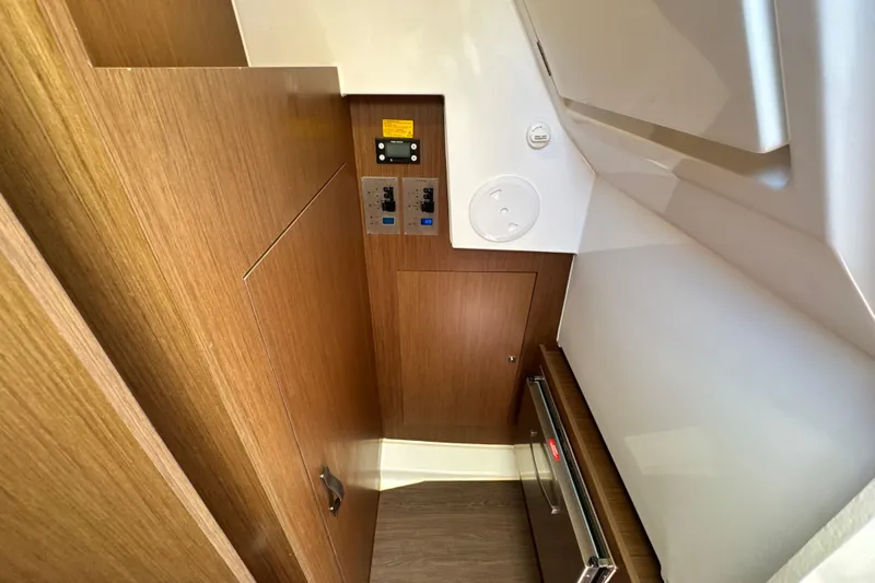 Slide: The Image of Interior of 2021 Beneteau Antares 11, featuring wood paneling and control panels. - 45