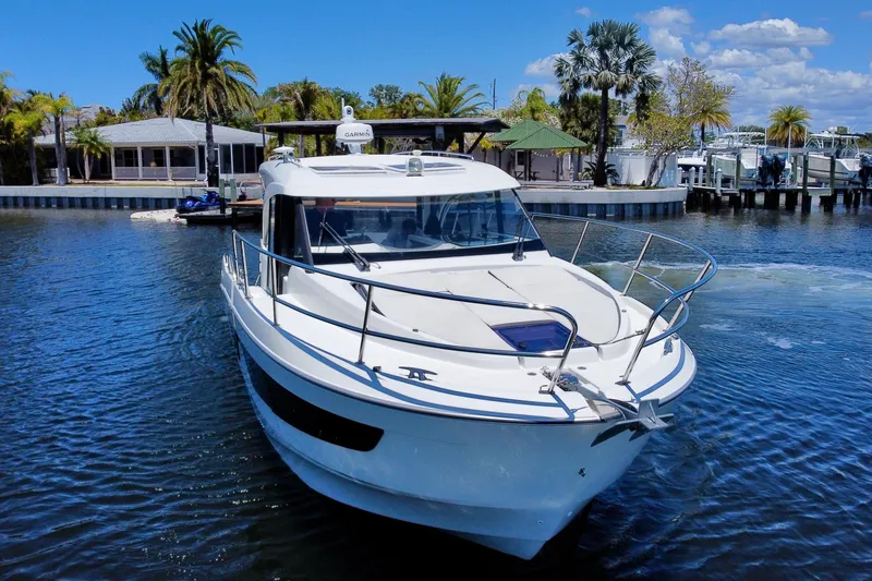 Slide: The Image of 2021 Beneteau Antares 11 boat docked in a sunny marina setting. - 5