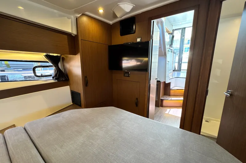 Slide: The Image of Interior of 2021 Beneteau Antares 11, featuring cozy cabin with TV and modern furnishings. - 51