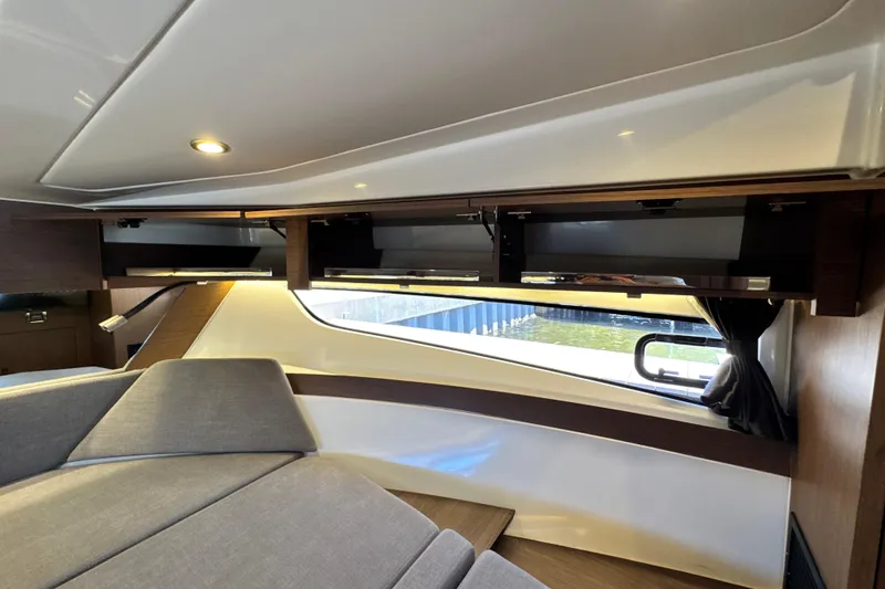 Slide: The Image of Interior of 2021 Beneteau Antares 11 with modern wood cabinetry and seating. - 54