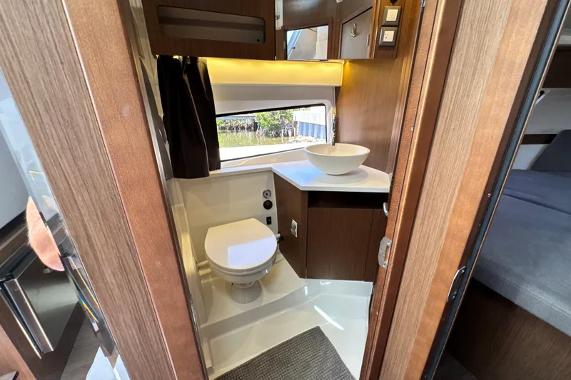 Slide: The Image of Interior of 2021 Beneteau Antares 11 yacht bathroom with modern fixtures and wood finish. - 55