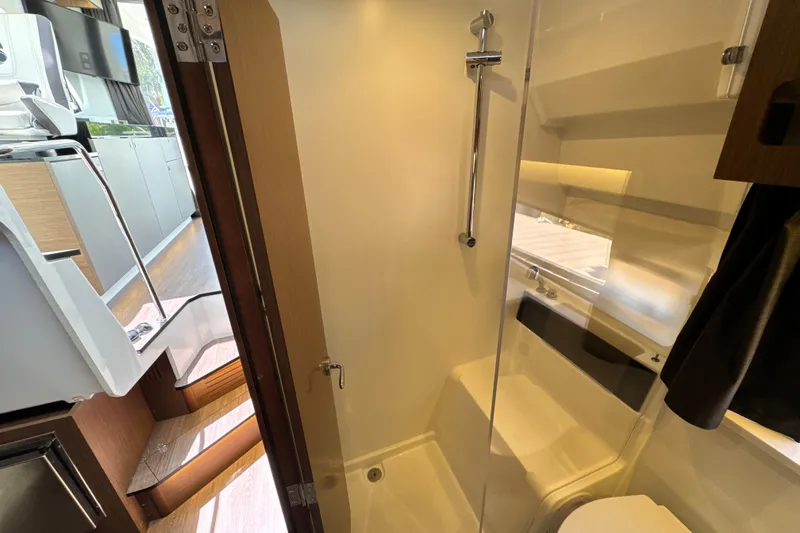 Slide: The Image of Interior view of 2021 Beneteau Antares 11 yacht bathroom and adjacent cabin area. - 57