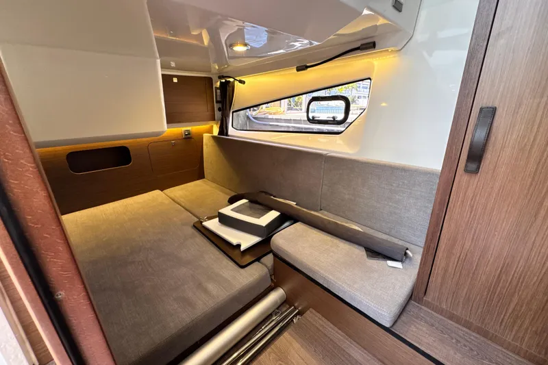 Slide: The Image of Interior cabin of 2021 Beneteau Antares 11 with modern furnishings and window view. - 59