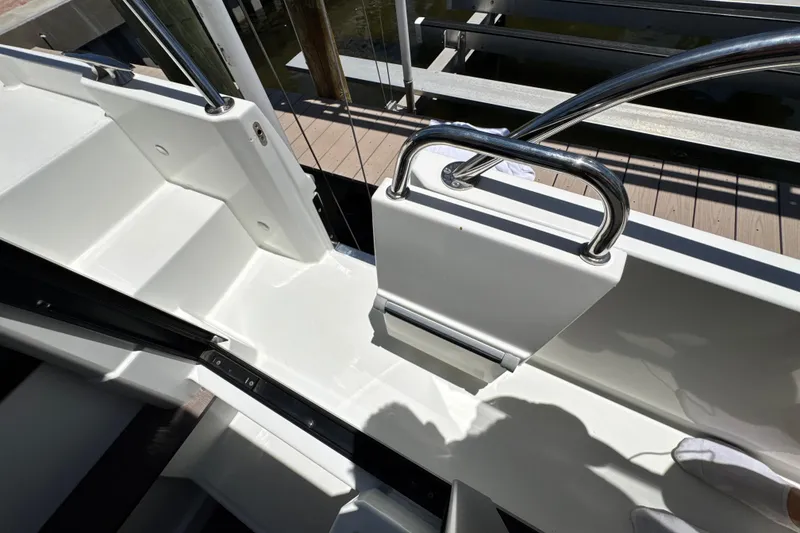 Slide: The Image of 2021 Beneteau Antares 11 boat deck with stainless steel railings and white seating area. - 62