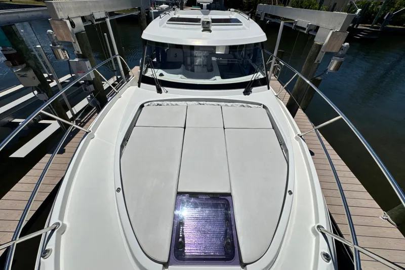 Slide: The Image of 2021 Beneteau Antares 11 boat docked, featuring spacious deck and sleek design. - 63
