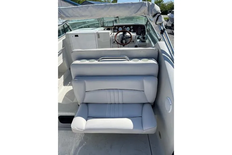 Slide: The Image of 1997 Crownline 250 CR boat interior with white seating and dashboard view. - 12