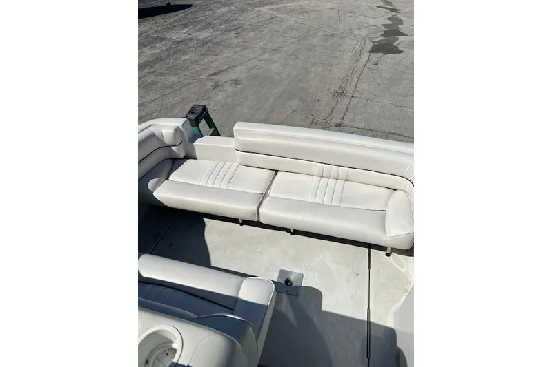 Slide: The Image of 1997 Crownline 250 CR boat with white leather seating on deck. - 13