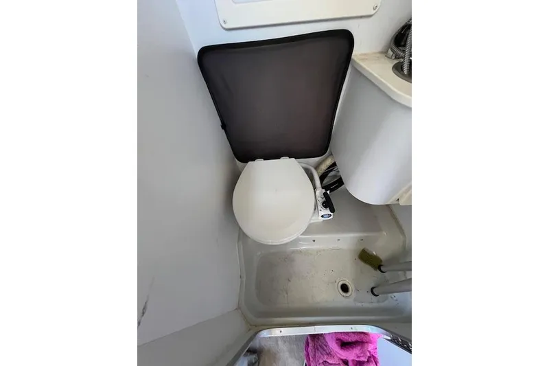Slide: The Image of 1997 Crownline 250 CR boat bathroom with toilet and sink. - 9
