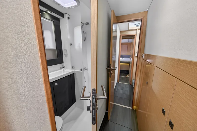 Slide: The Image of Interior of 2015 Fountaine Pajot Helia 44 yacht, featuring a modern bathroom and hallway. - 104
