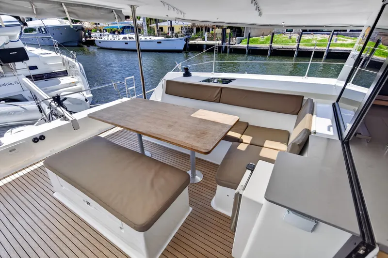 Slide: The Image of Spacious deck seating on 2015 Fountaine Pajot Helia 44 catamaran, docked at marina. - 14