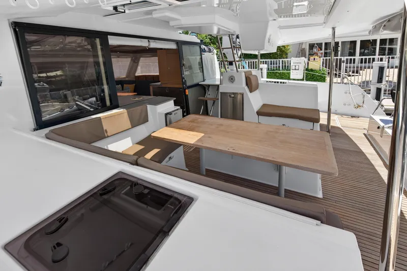 Slide: The Image of Spacious deck of 2015 Fountaine Pajot Helia 44 catamaran with seating and dining area. - 16