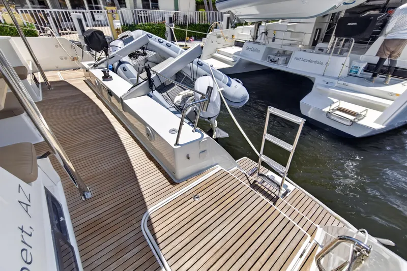 Slide: The Image of Fountaine Pajot Helia 44 catamaran, 2015 model, docked with wooden deck and dinghy. - 20