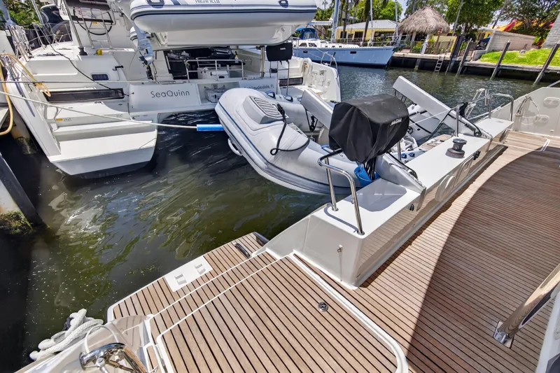 Slide: The Image of 2015 Fountaine Pajot Helia 44 catamaran with dinghy, docked in a marina. - 21
