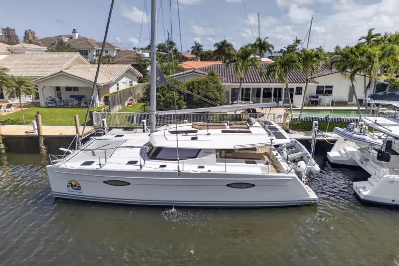Slide: The Image of 2015 Fountaine Pajot Helia 44 catamaran docked near waterfront homes. - 3