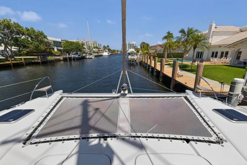 Slide: The Image of 2015 Fountaine Pajot Helia 44 catamaran docked in a scenic waterfront setting. - 35