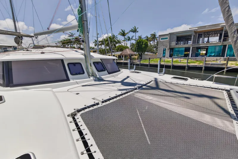 Slide: The Image of 2015 Fountaine Pajot Helia 44 catamaran docked near modern waterfront property. - 36