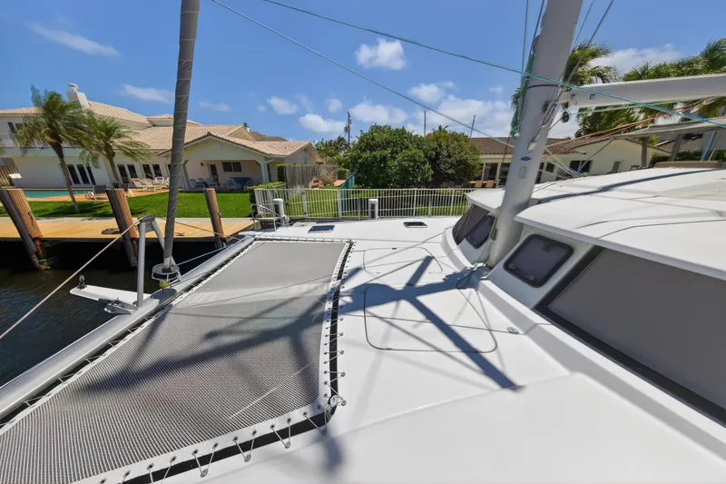 Slide: The Image of 2015 Fountaine Pajot Helia 44 catamaran docked near waterfront homes. - 38