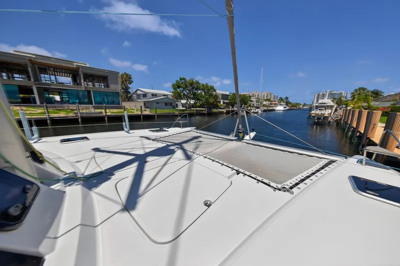 Slide: The Image of 2015 Fountaine Pajot Helia 44 catamaran docked in a scenic waterfront area. - 43