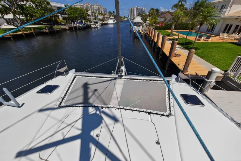 Slide: The Image of 2015 Fountaine Pajot Helia 44 catamaran docked in a scenic canal setting. - 46